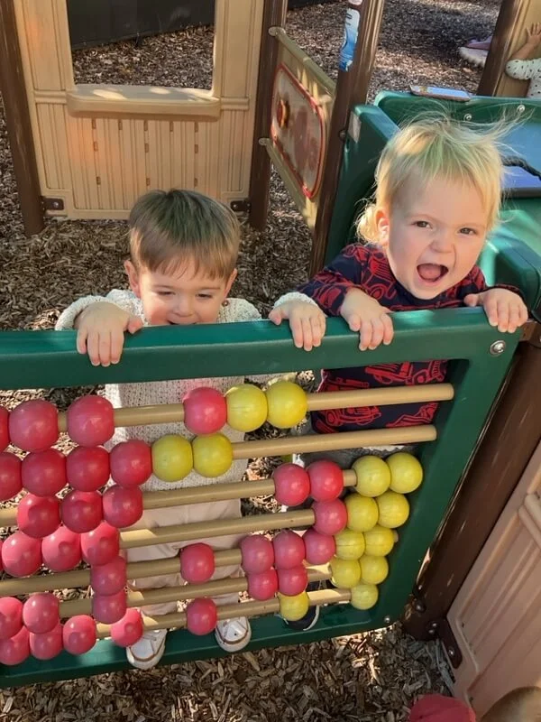 toddlers spend time on our outdoor playgrounds building motor skills
