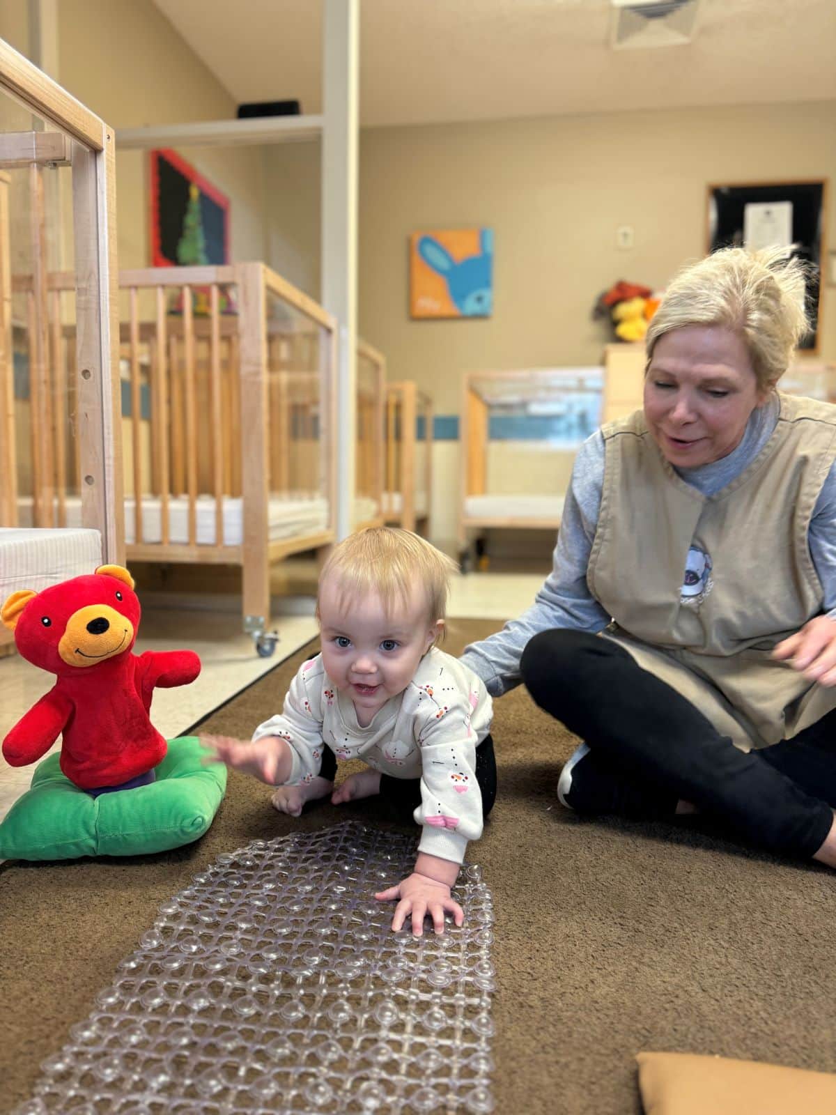 Baby crawling with teacher 