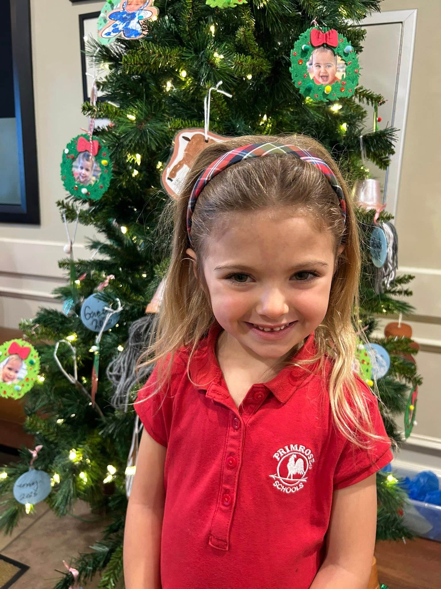 a child in front of a decorated tree