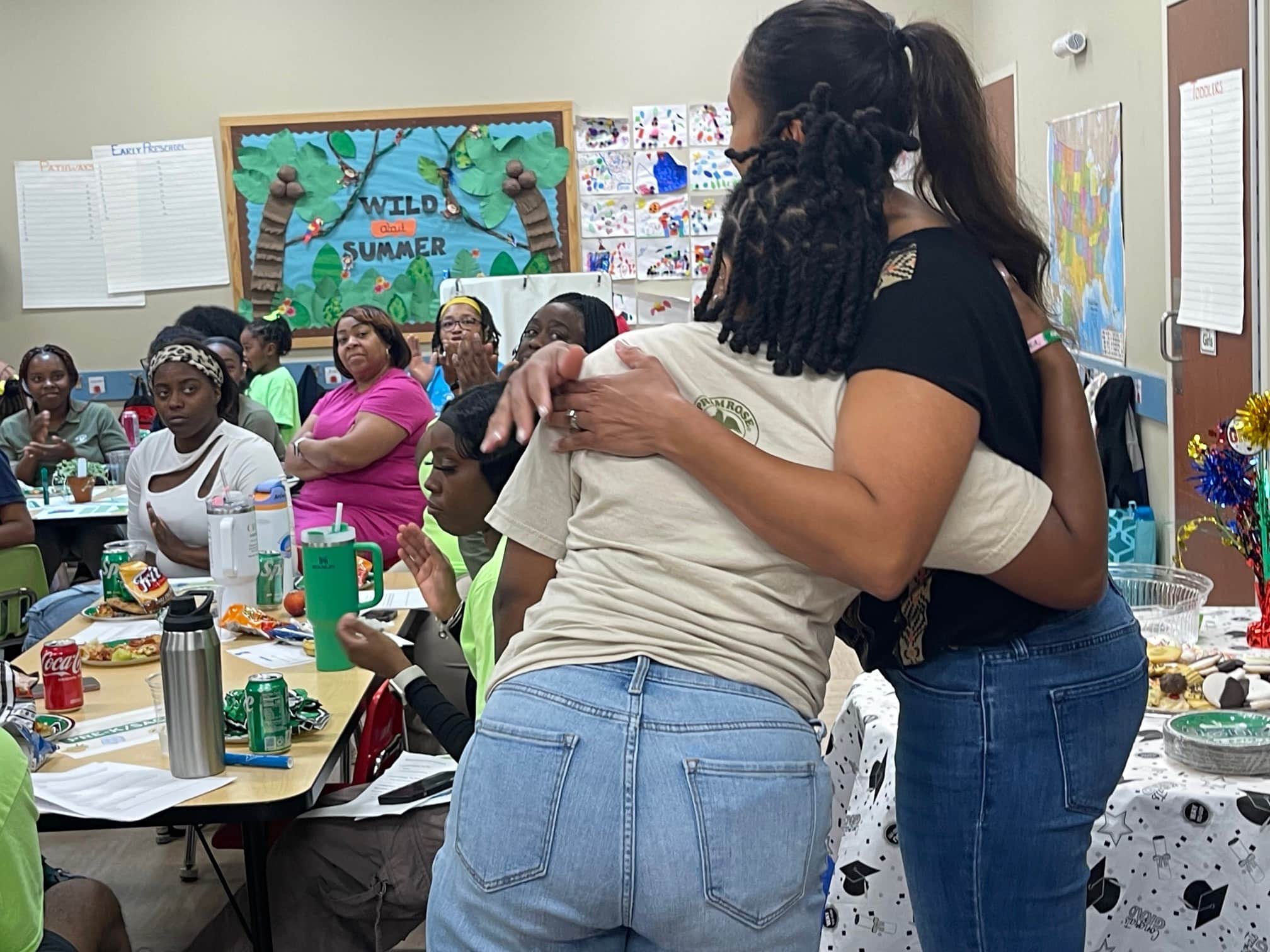 two teachers hugging