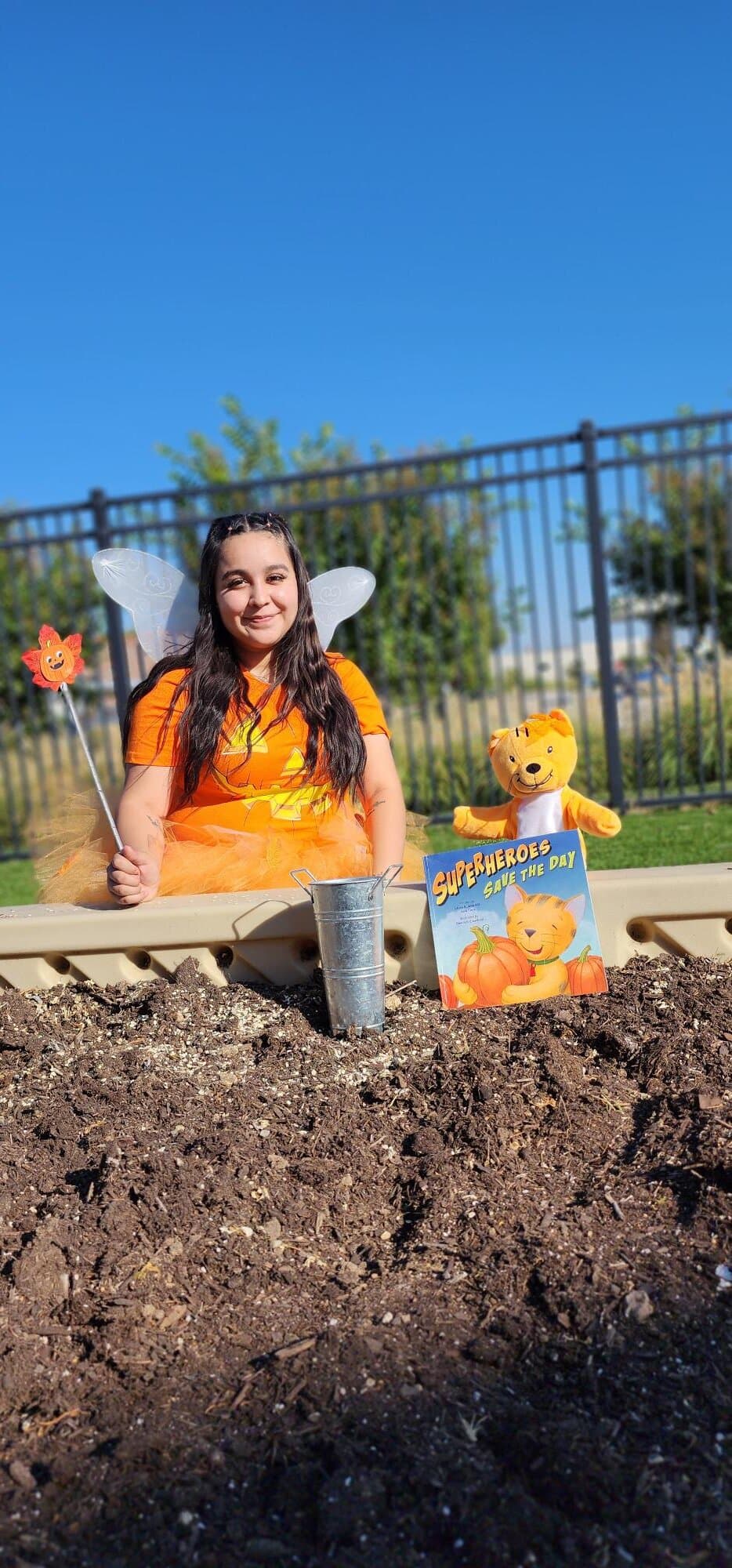 Special classroom visitor supporting an imaginative fall learning activity