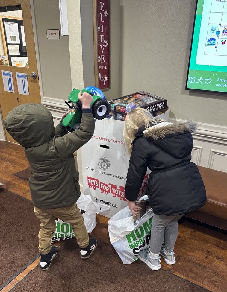 Children from Primrose School of Eagan donating toys to the Toys for Tots collection box, Eagan MN