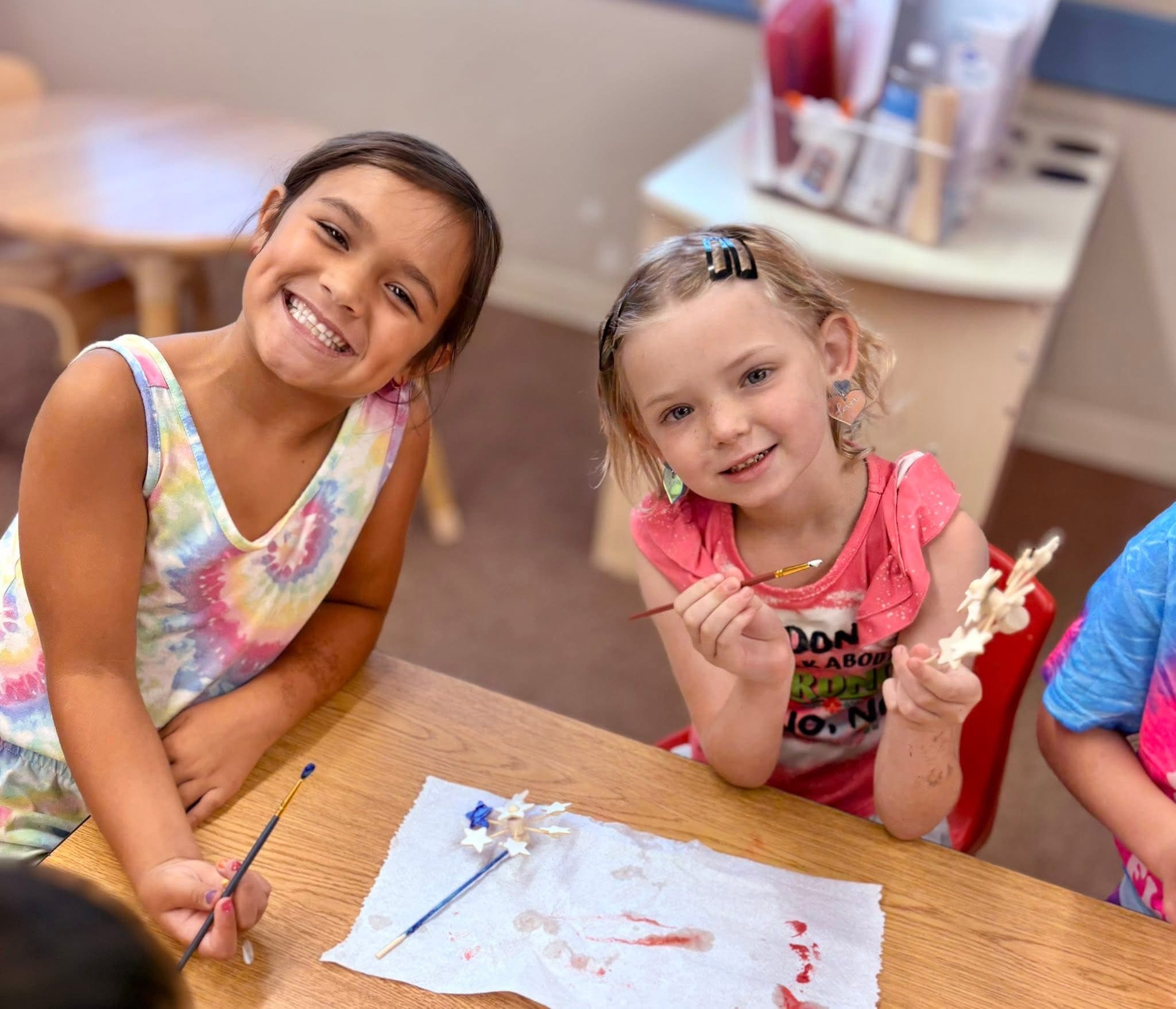two elementary aged students working on a craft in their after school program.