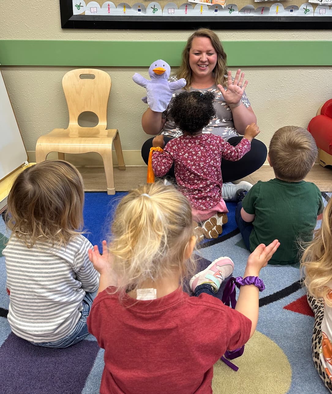 Teacher Elissa leading early preschool circle time with puppet play at Primrose School of Eagan in Eagan, MN