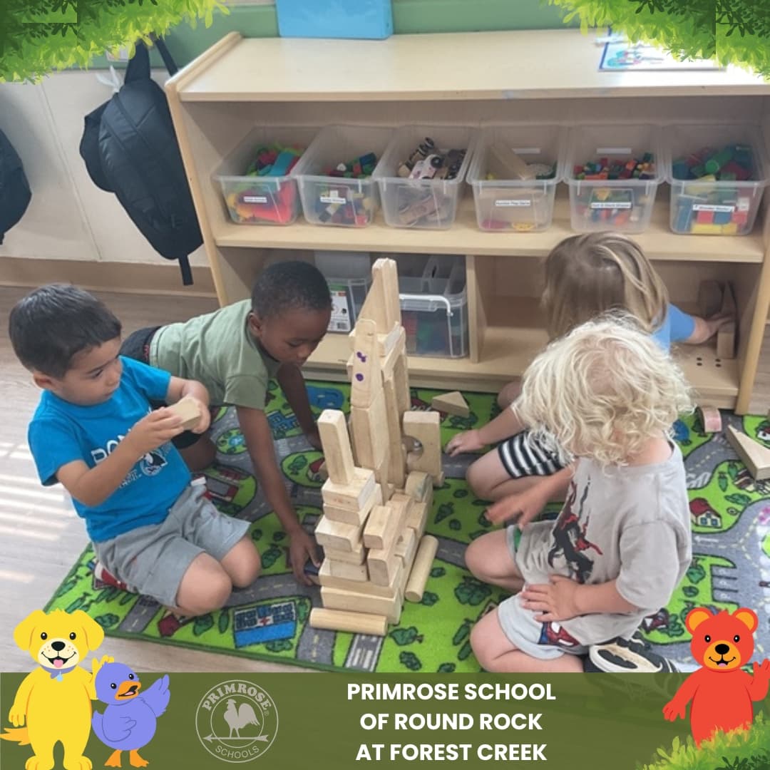 Children at Primrose School of Round Rock at Forest Creek building wooden block structures during a hands-on classroom STEM activity.