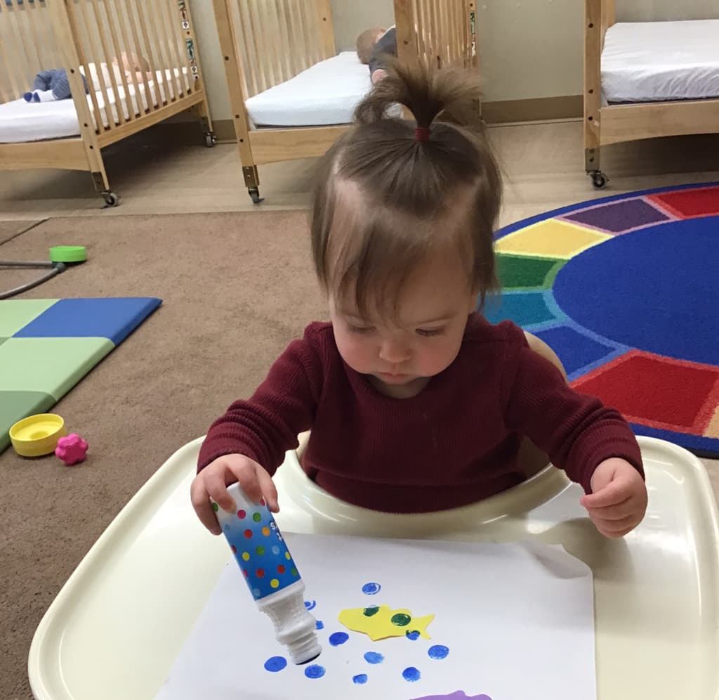 A infant doing art
