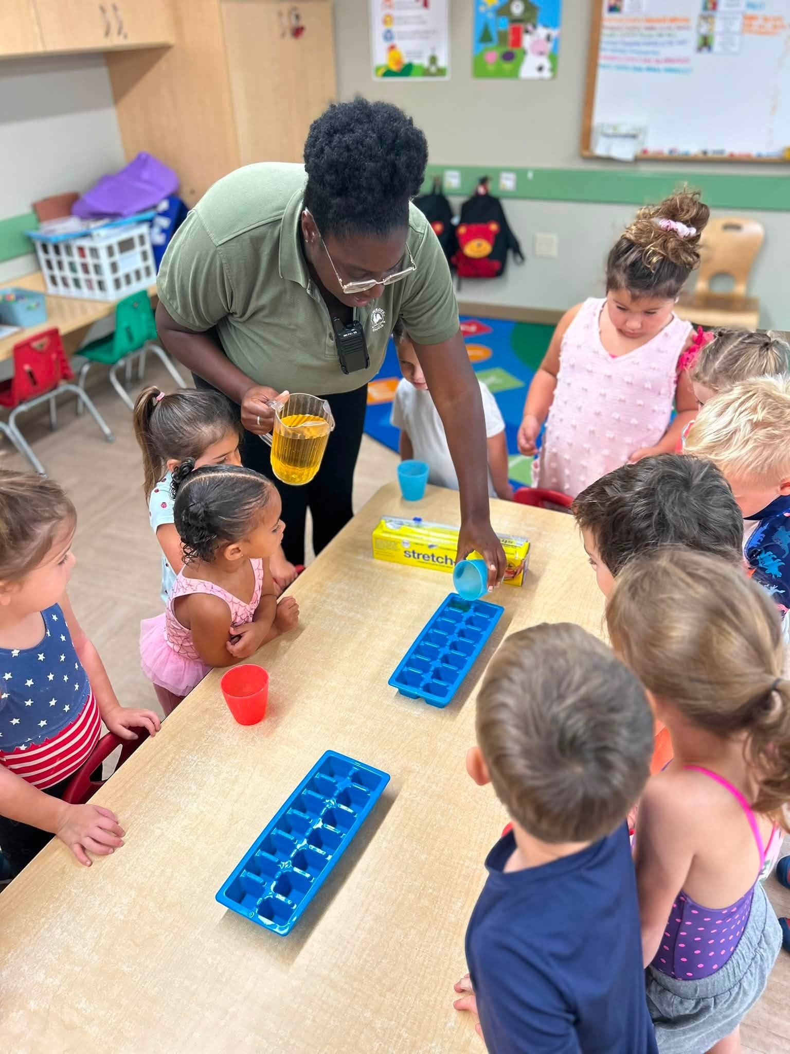 A student making juice pops with their teacher 
