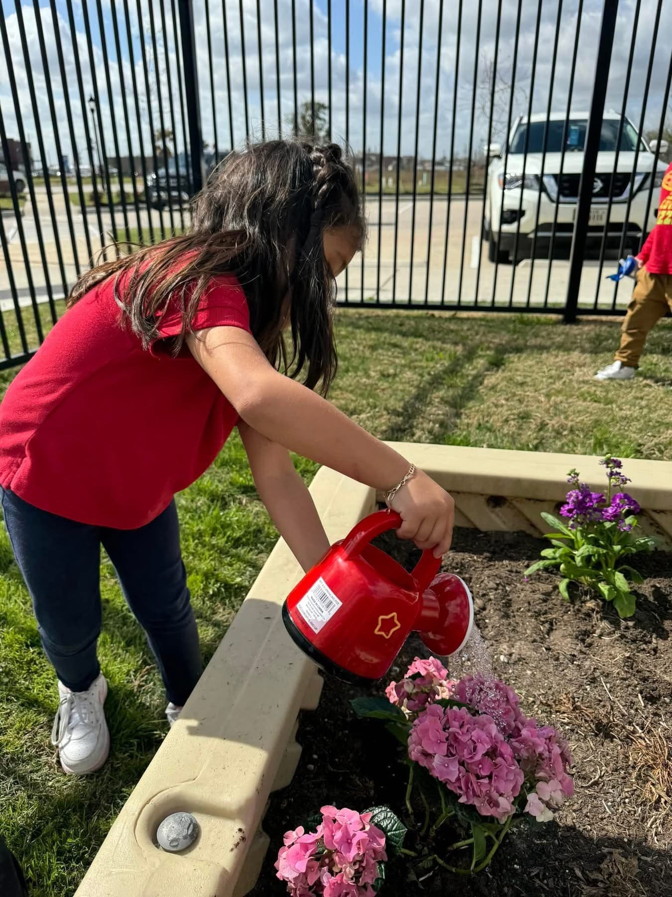 child gardening, watering flowers, sensory play, education