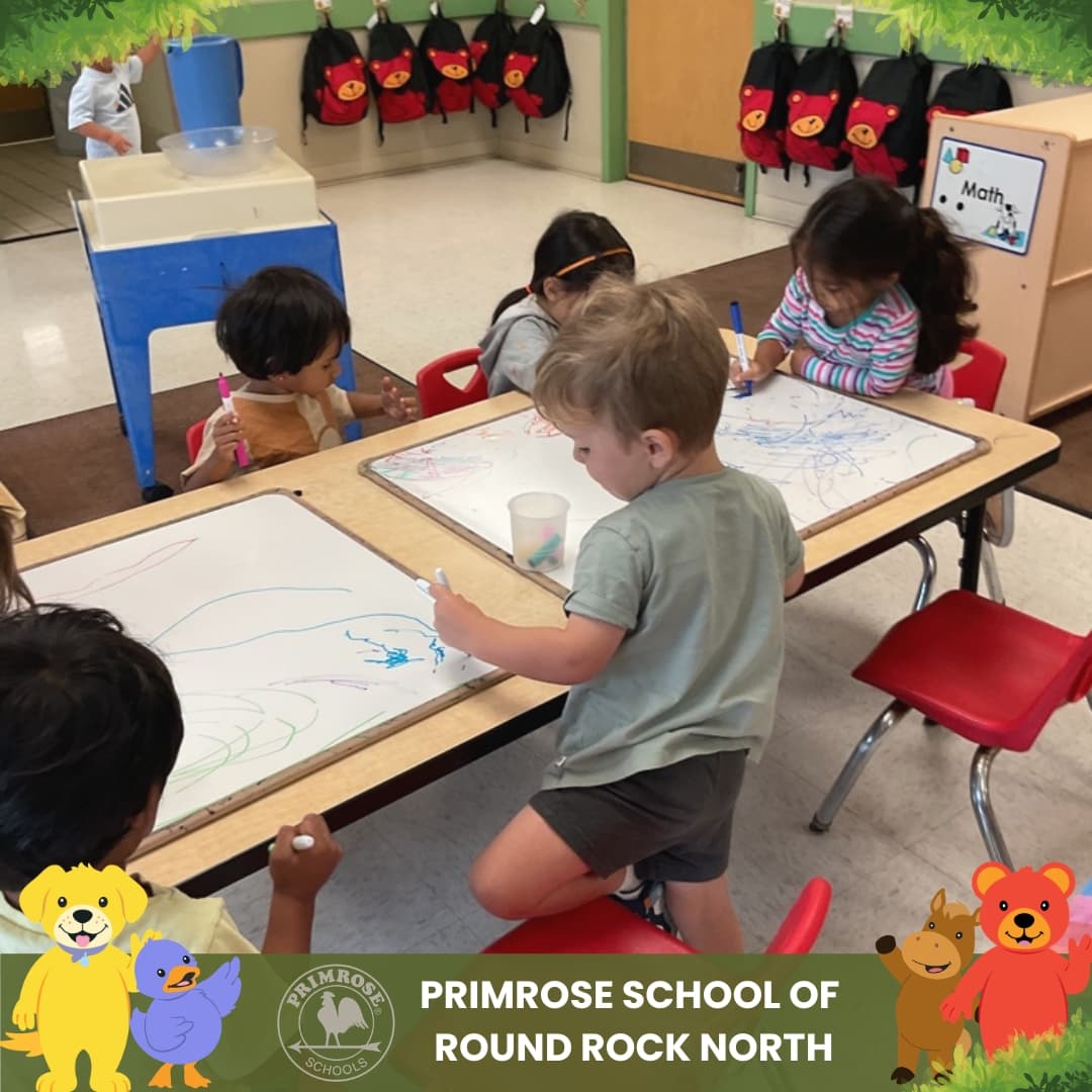 Children at Primrose School of Round Rock North creating colorful artwork during a classroom art and early writing activity.