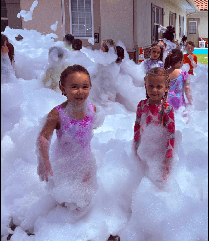 children smiling in foam party