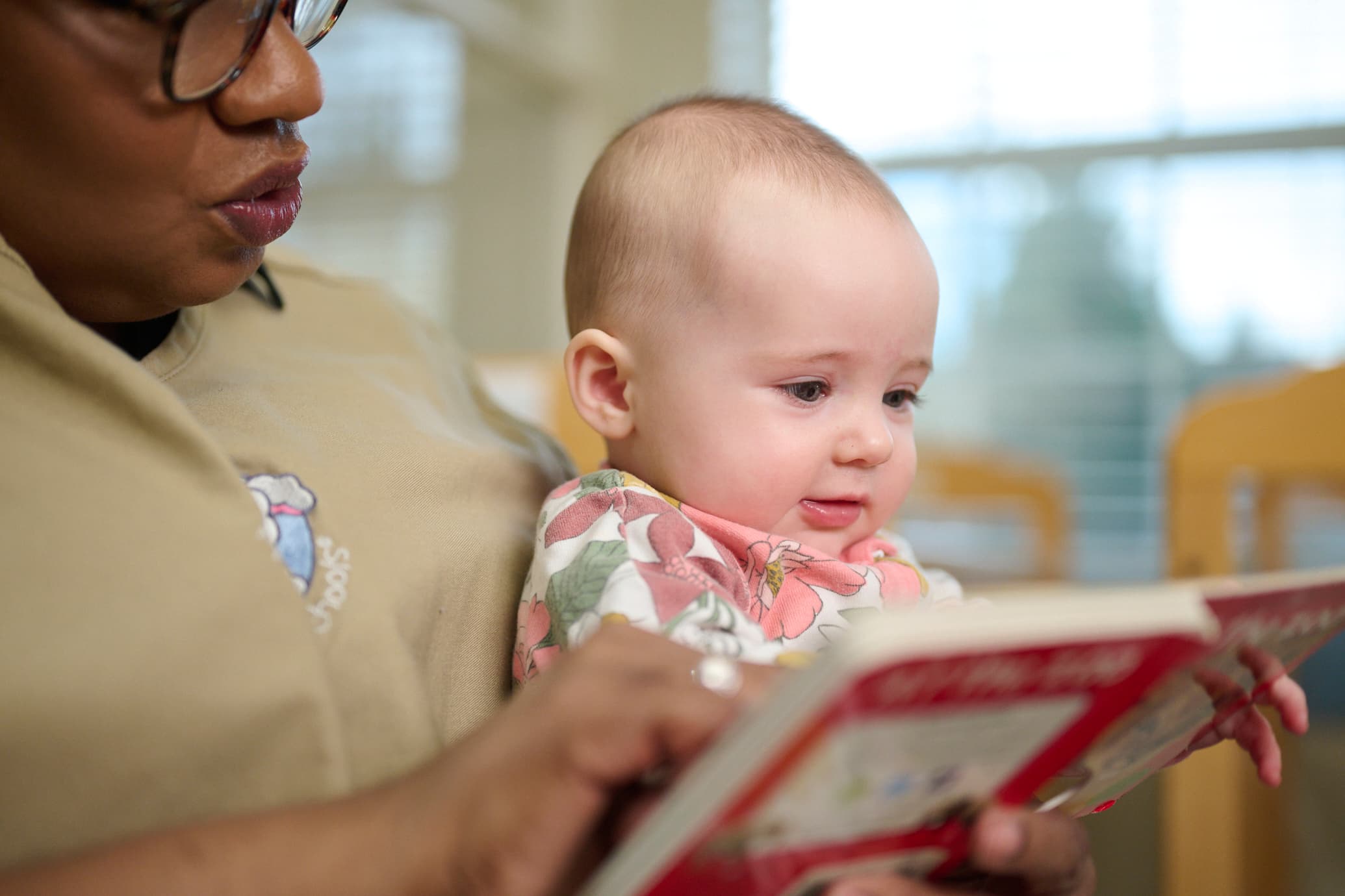 Teacher reading to an infant