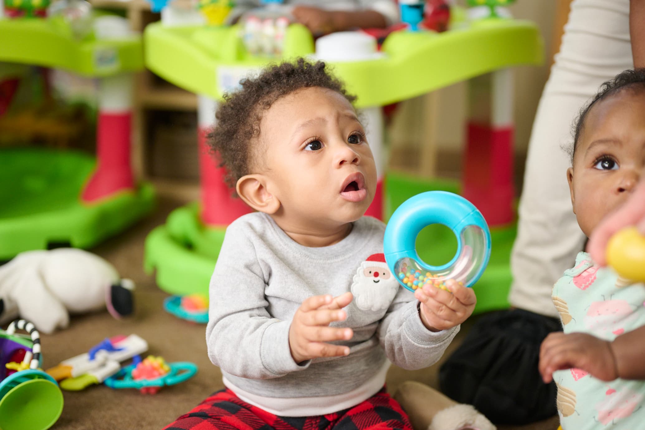Infant playing with circular toy