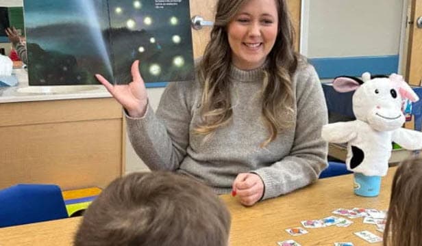 Teacher Tayci leading a science storytime lesson with children at Primrose School of Eagan preschool in Eagan, MN