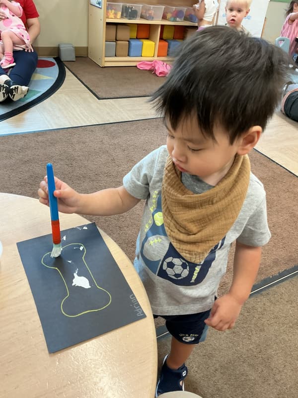 child painting in the classroom