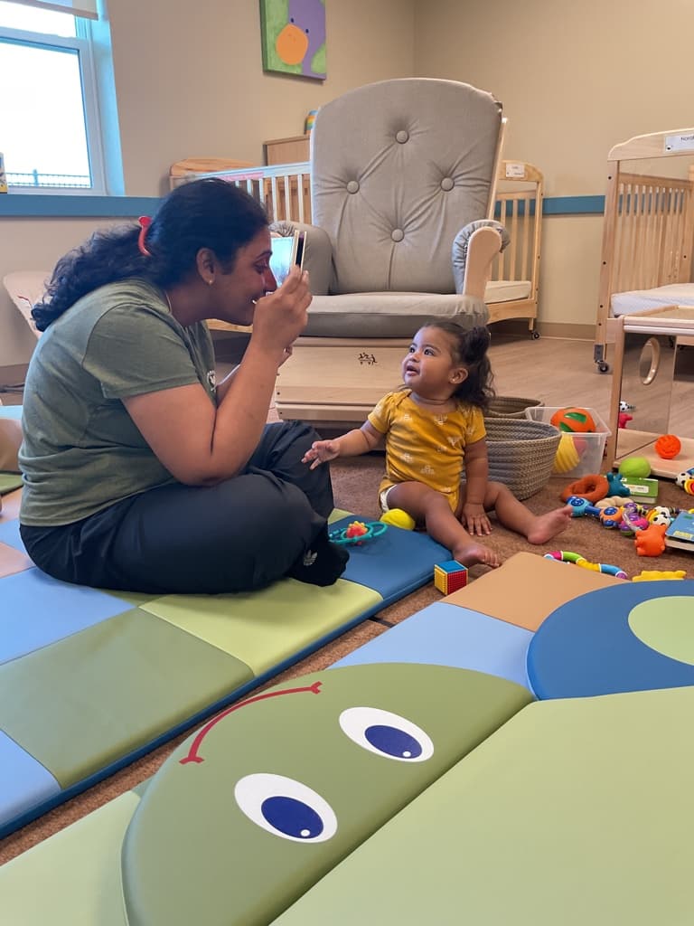 teacher playing with infant