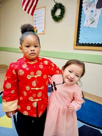 Two children posing in traditional Lunar New Year clothing