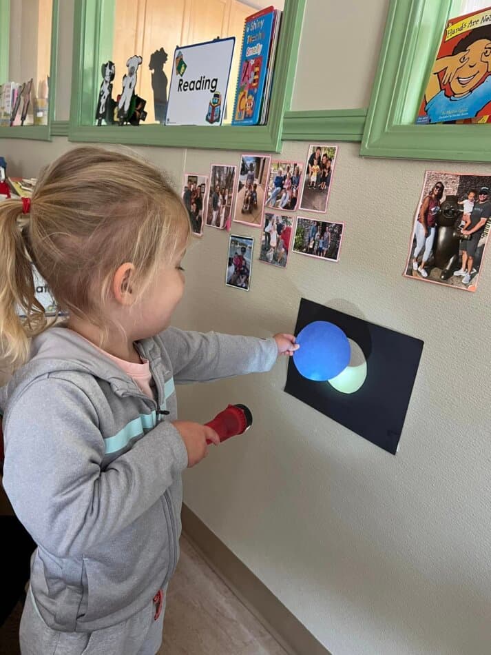 children conducting solar eclipse replica