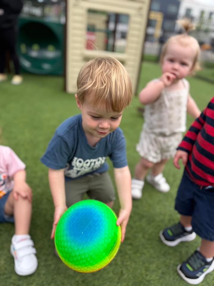 Toddler Thumb's Up Rolling the ball