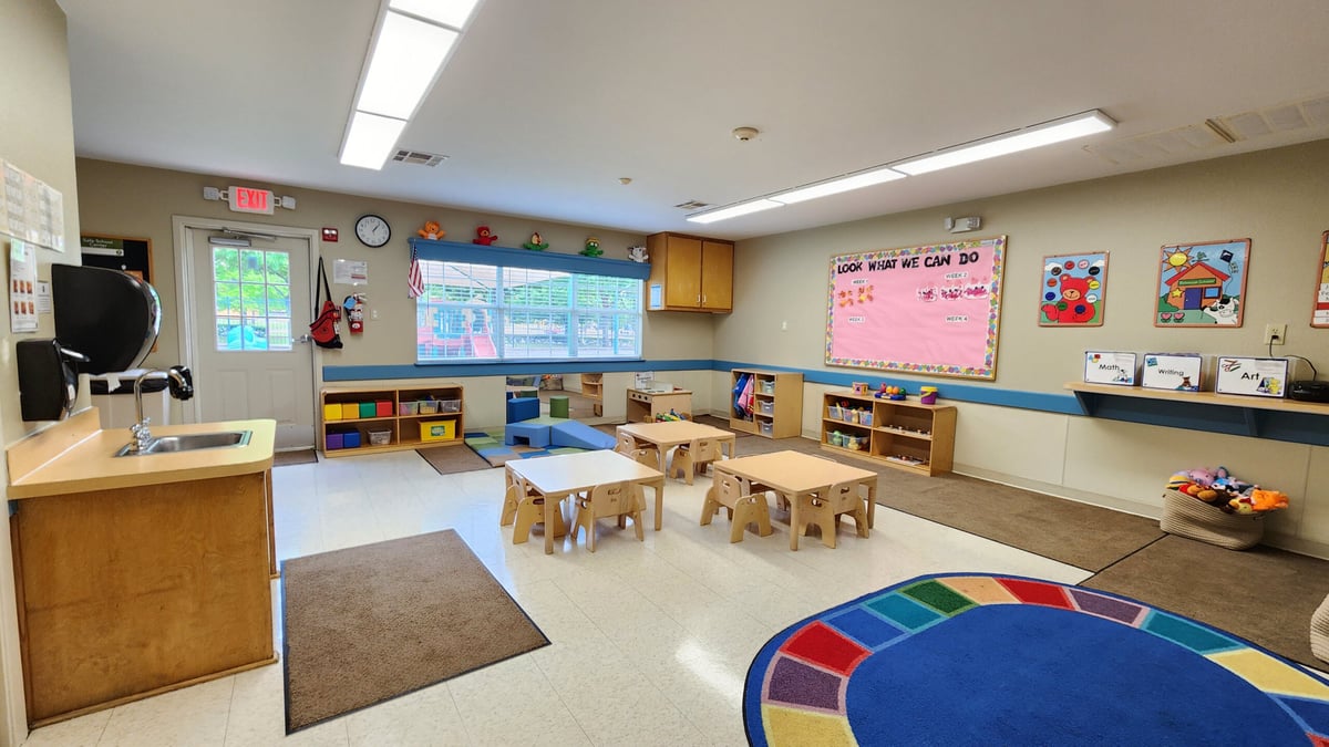 "Young Toddler Classroom, Neatly arranged safe tables and chairs, Colorful Play Equipment, and Stimulating Early Childhood Development Activities"