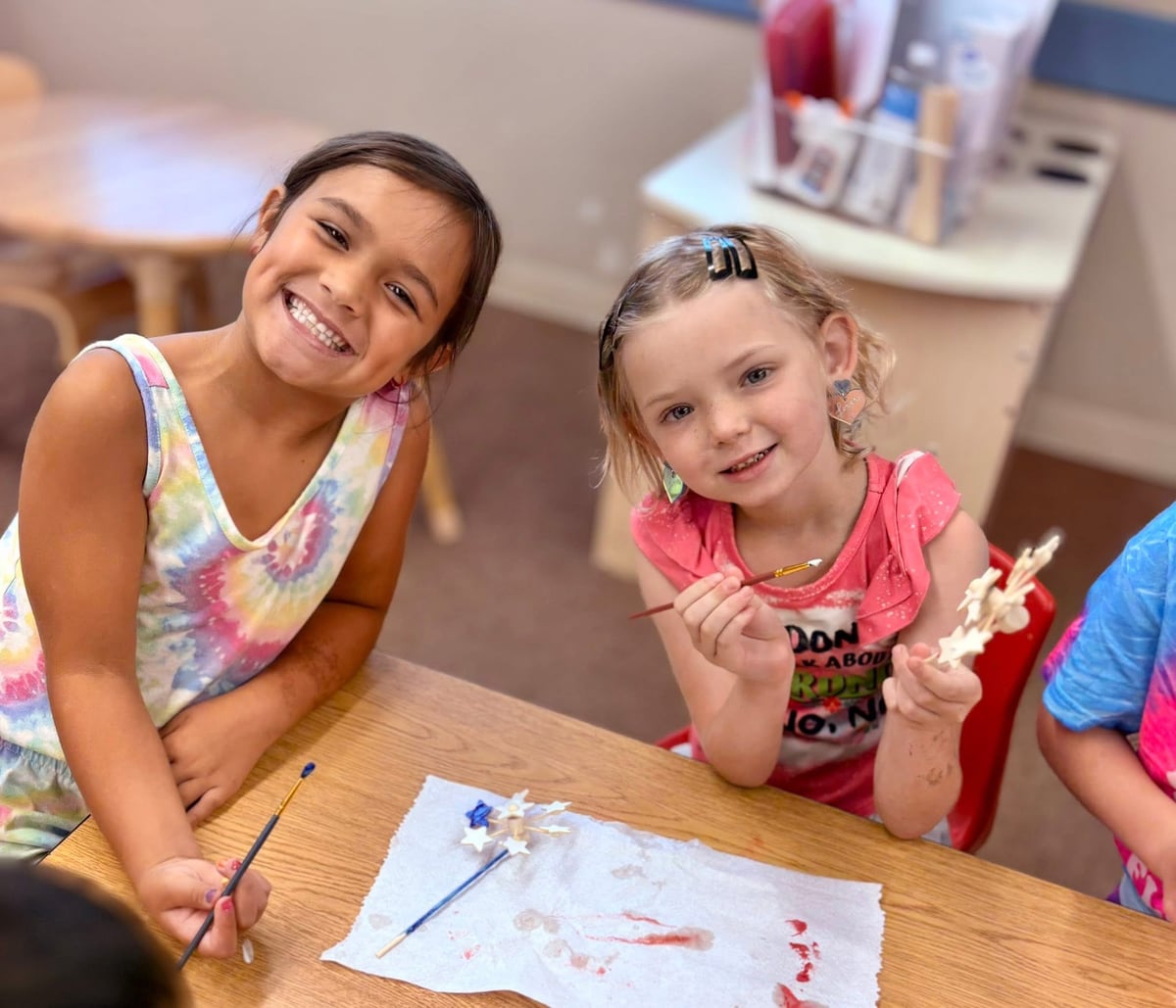 two elementary aged students working on a craft in their after school program.
