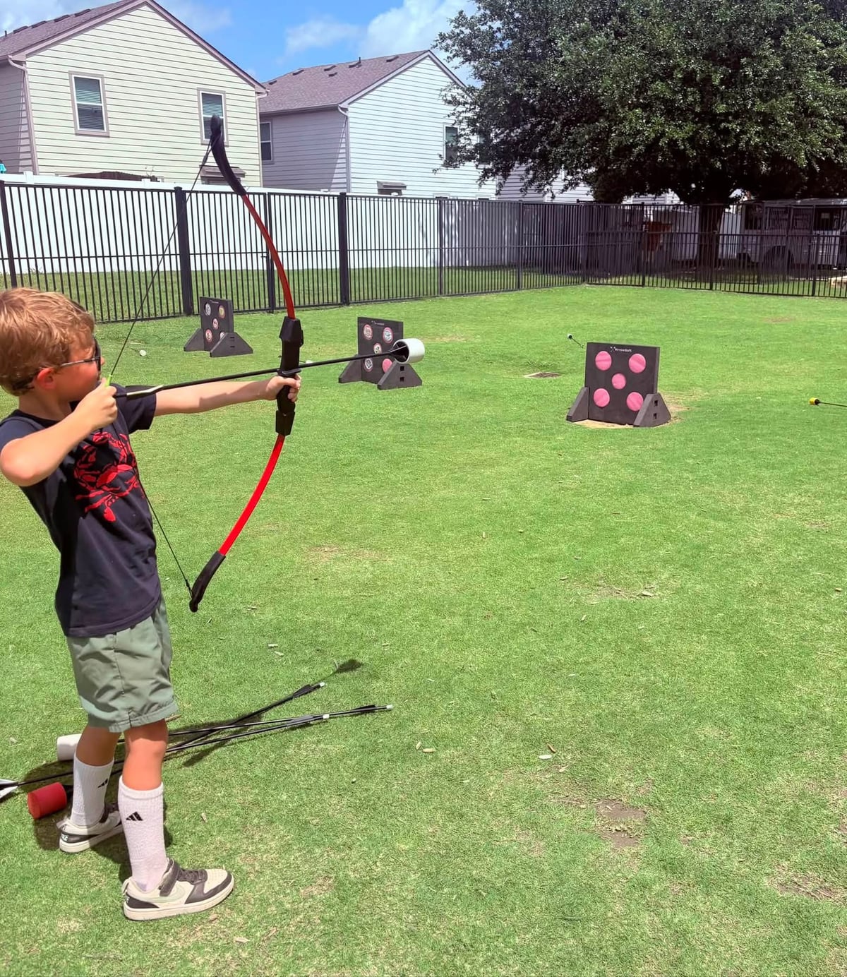Child at Primrose Summer program doing archery
