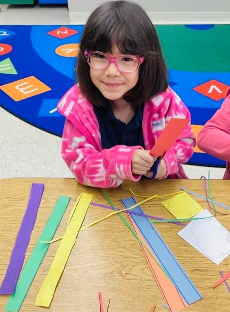 Kindergarten kid working on a colorful art project at primrose school in Eagle Ranch