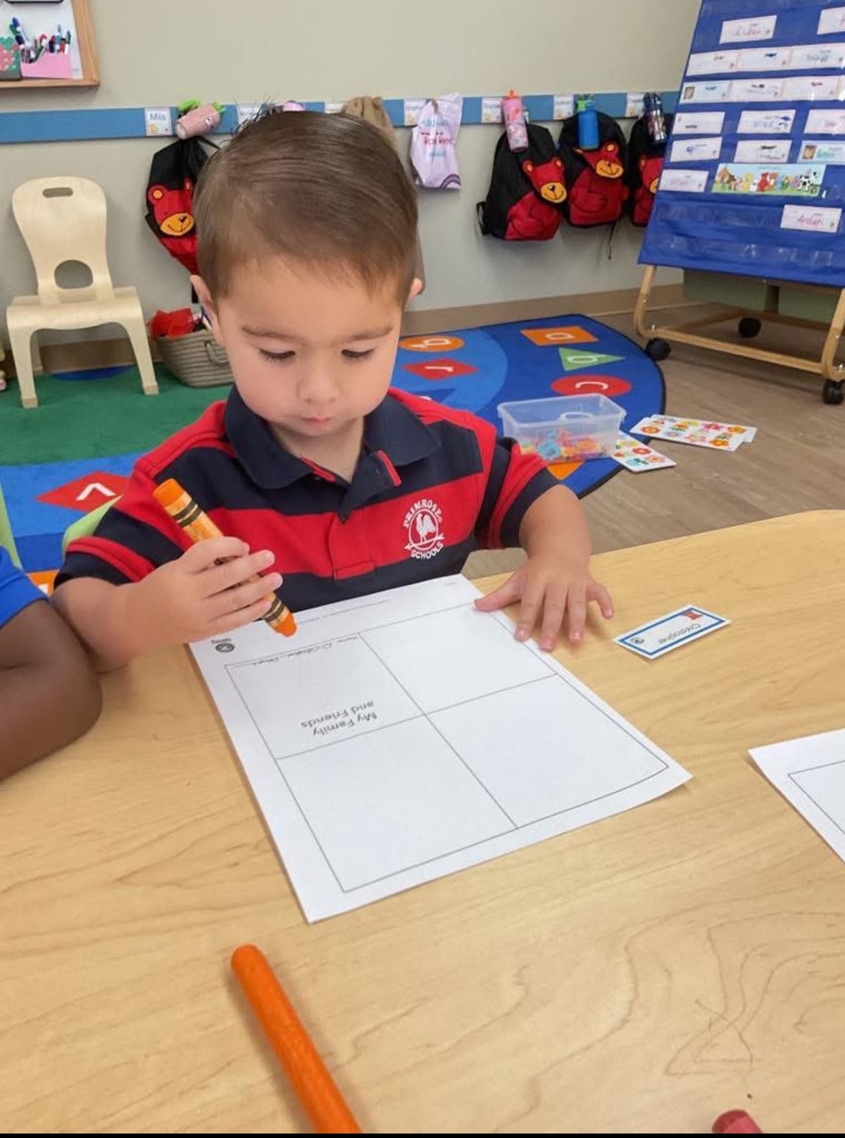 Preschool student creating mini book 