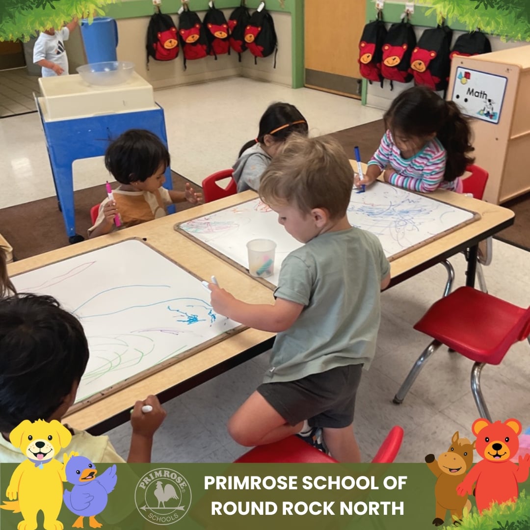Children at Primrose School of Round Rock North creating colorful artwork during a classroom art and early writing activity.