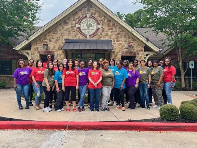 Group of teachers in front of school