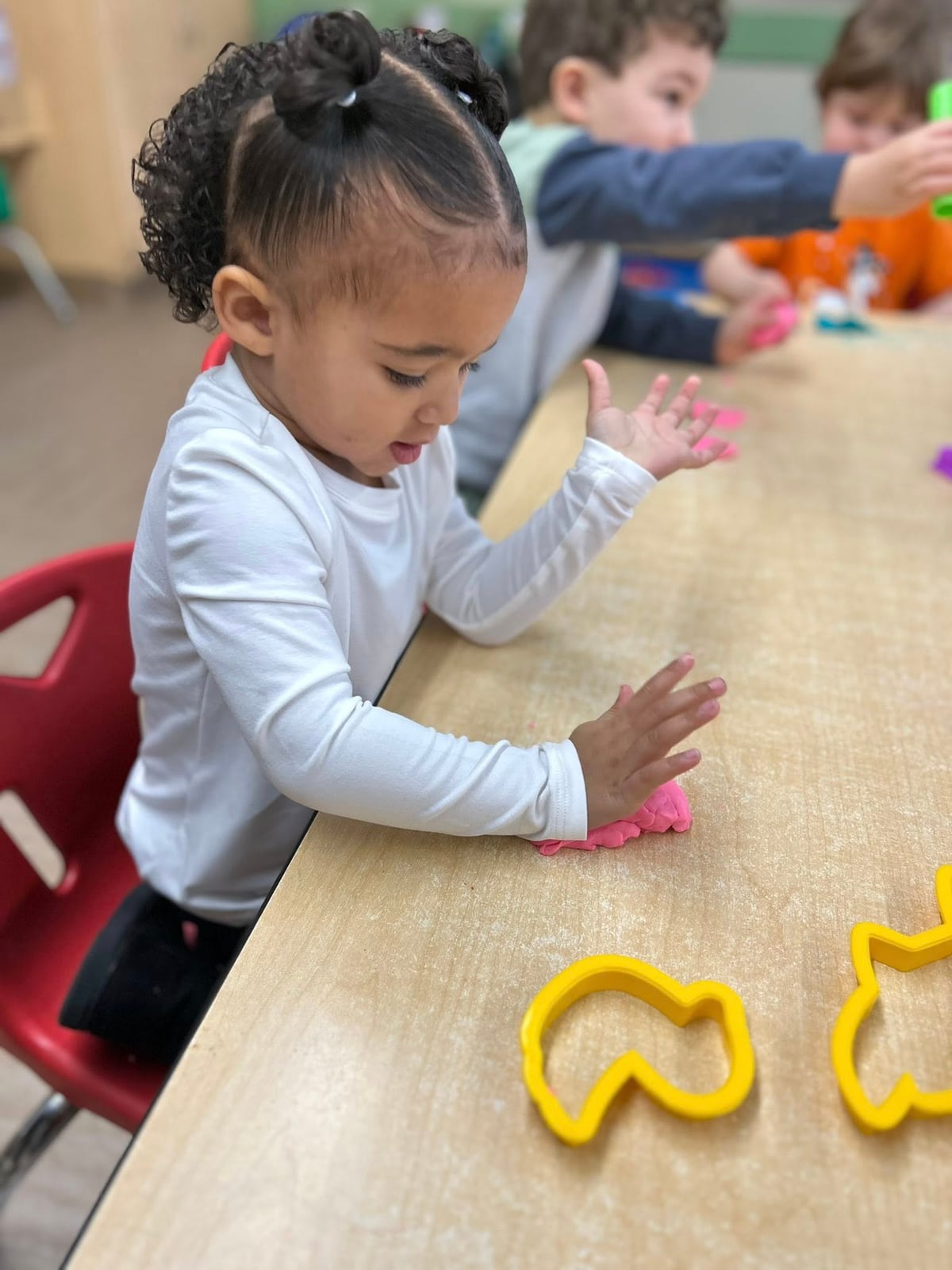 A child playing with modeling dough