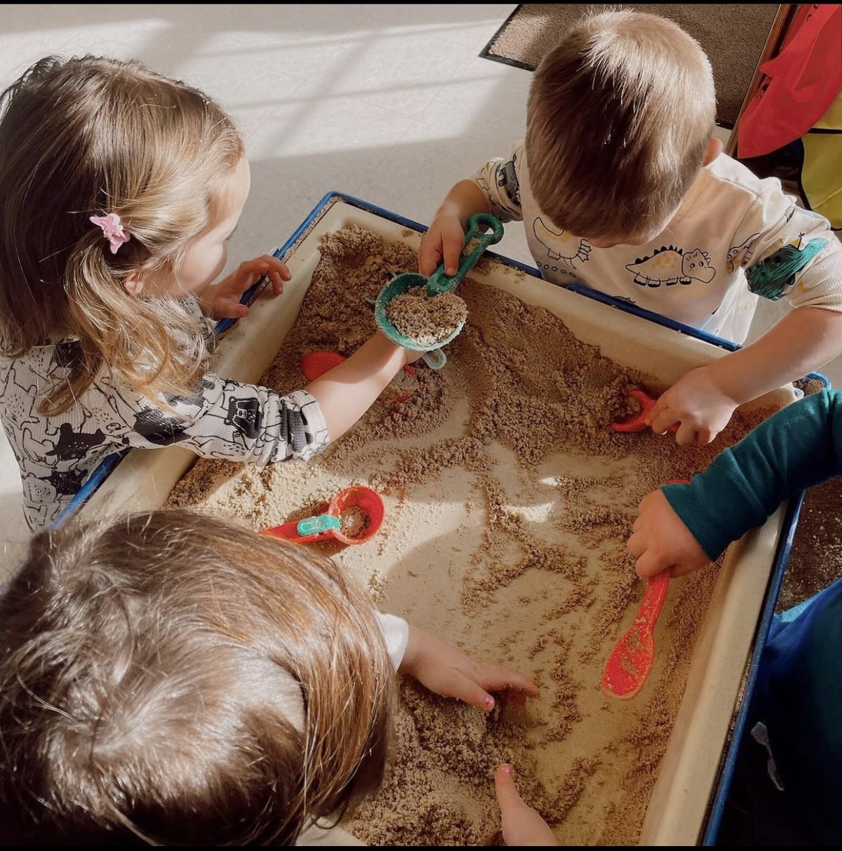 Students playing in sand box
