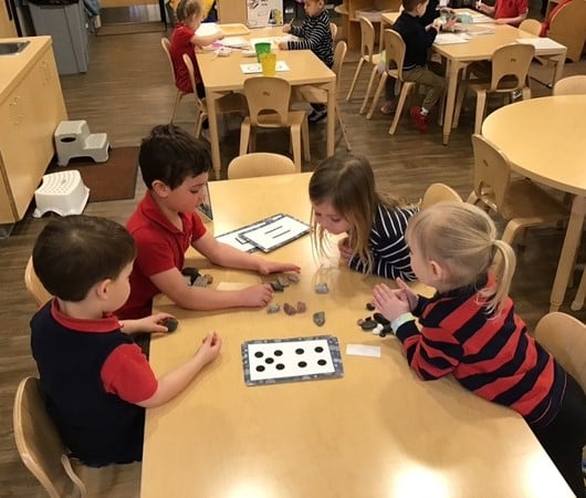 Student shares book with classmates