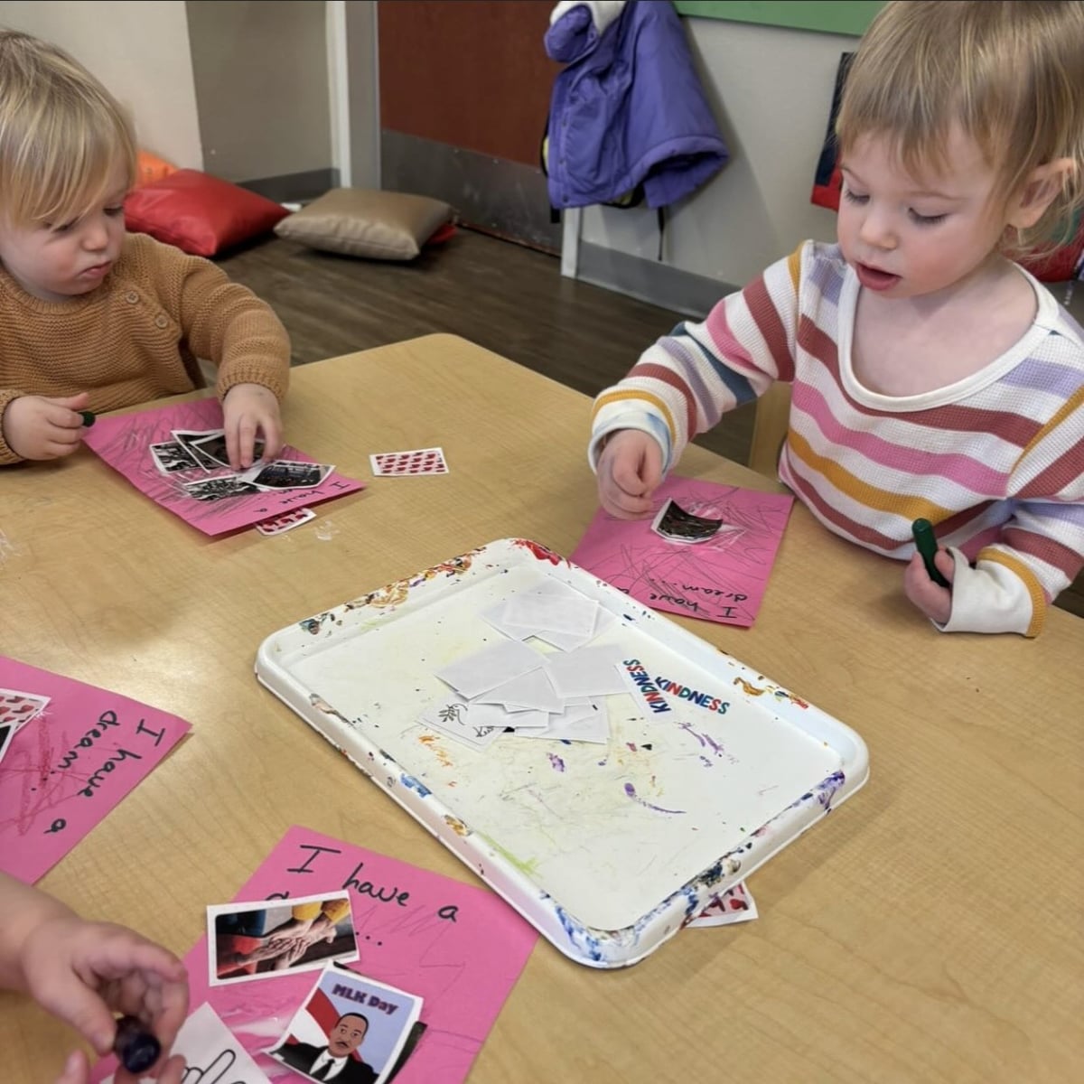 Toddlers participating in sticker activity 
