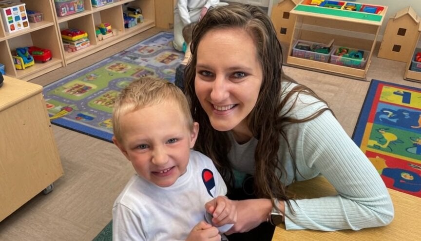 A Primrose School of Eagan manager with her son during the annual Muffins with Mom Mother's Day breakfast event, May 2026.