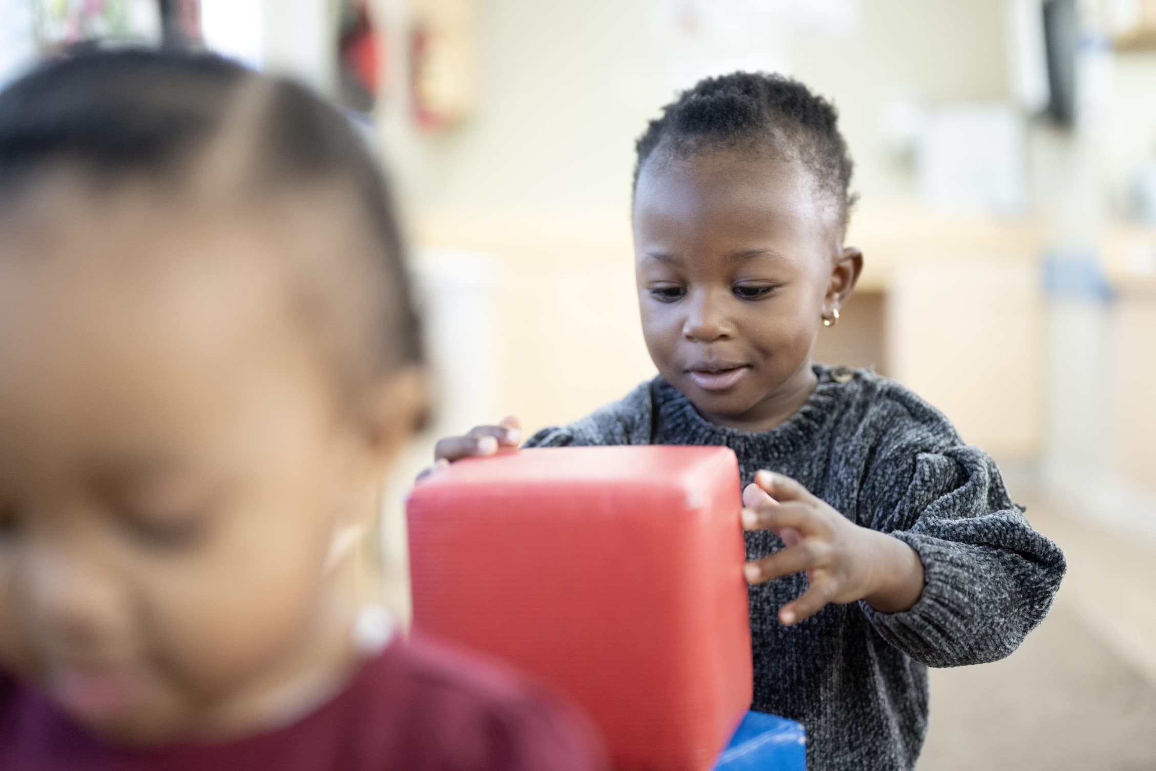 preschool student playing with building blocks