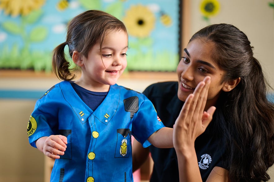 little girl playing dress up at primrose