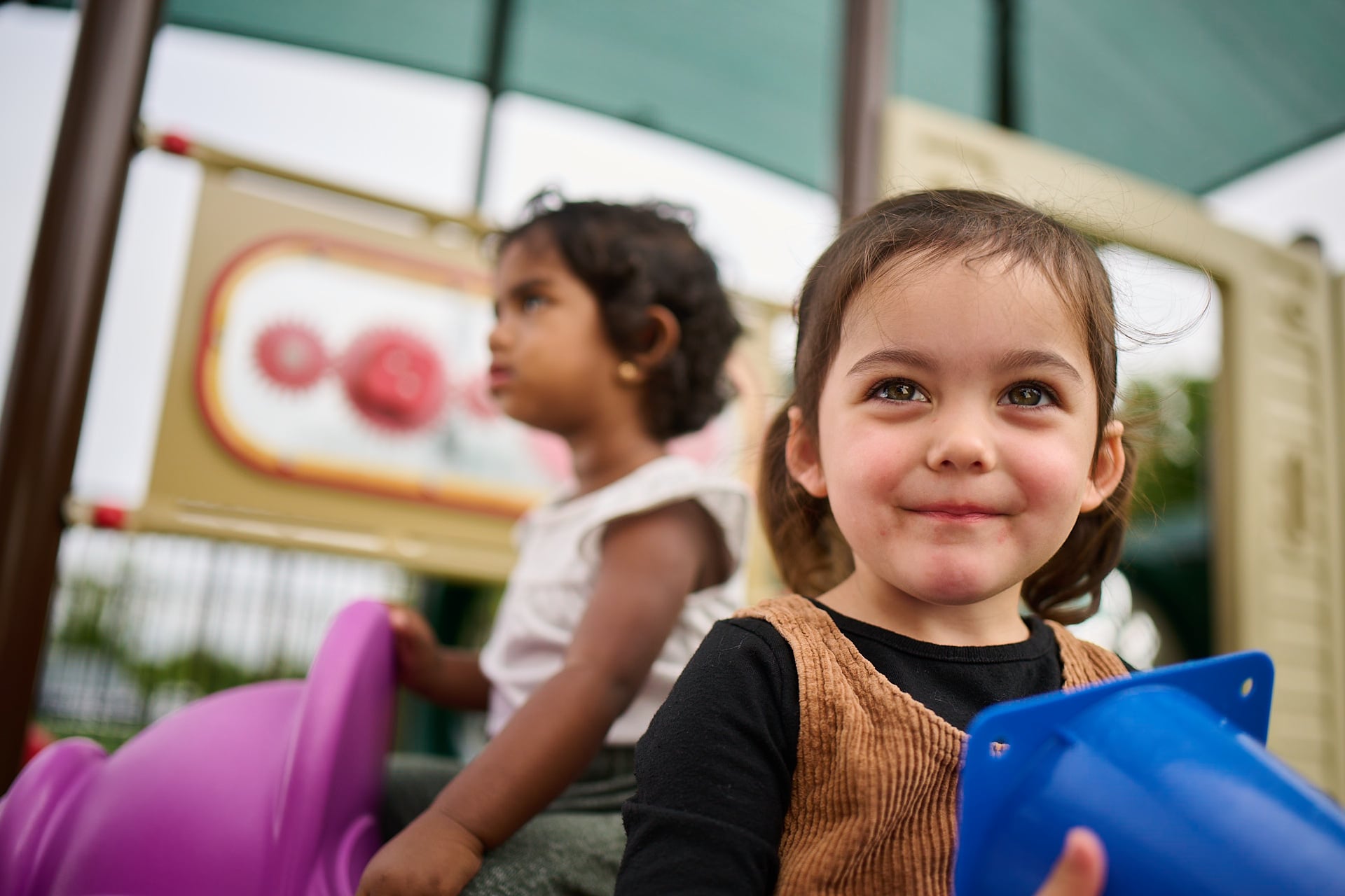 young preschoolers playing on the playground