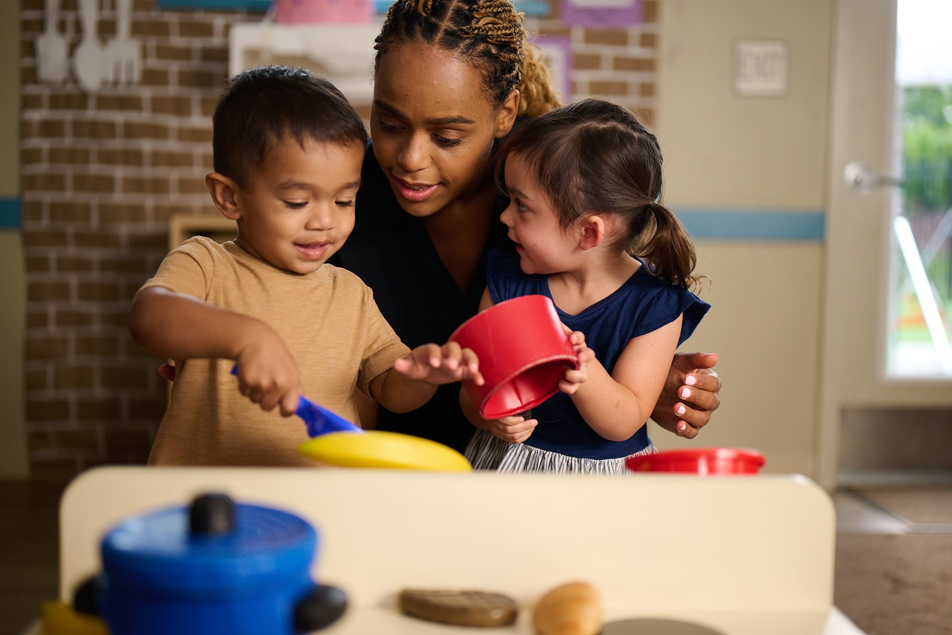teacher guiding children in play