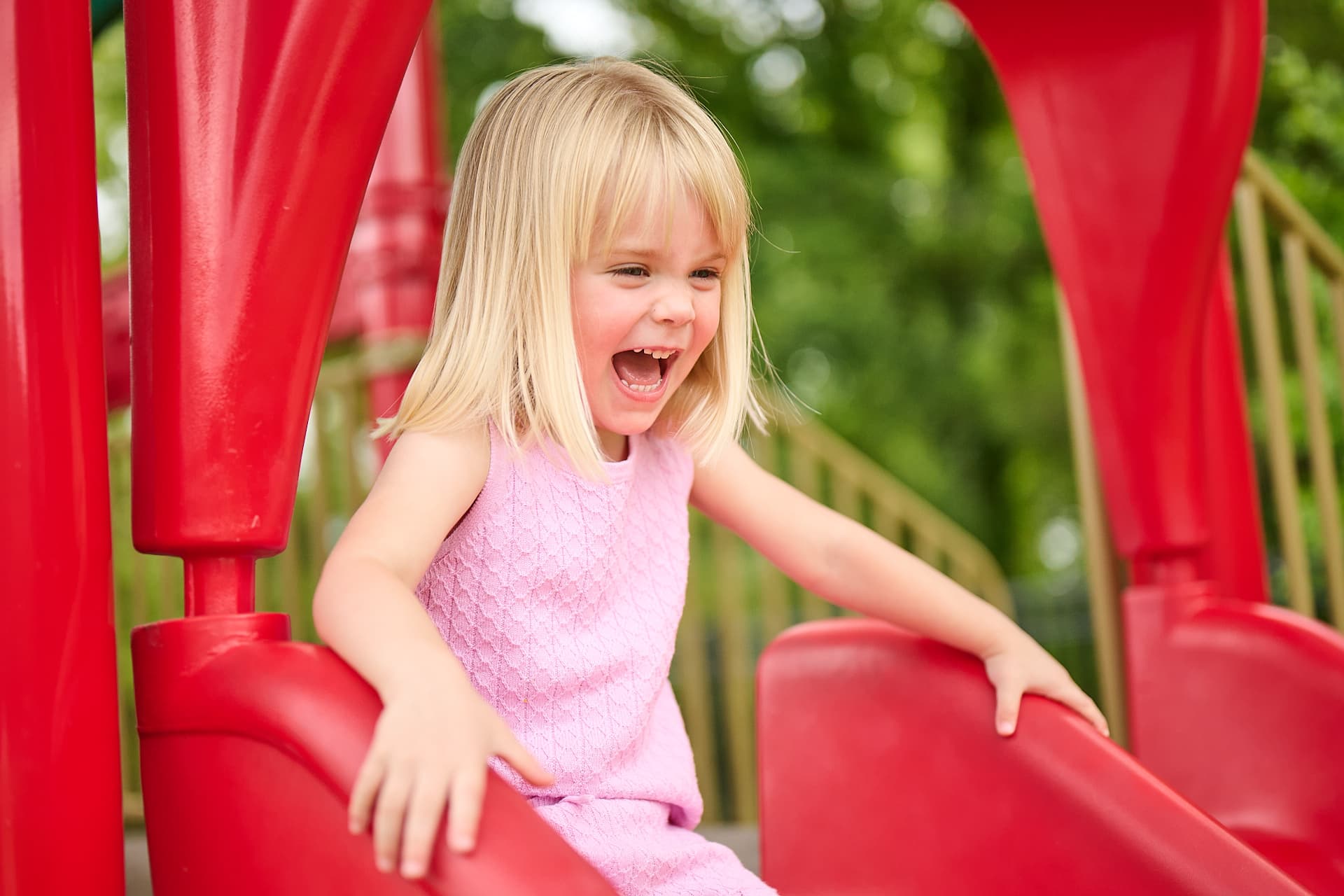 preschooler going down the slide