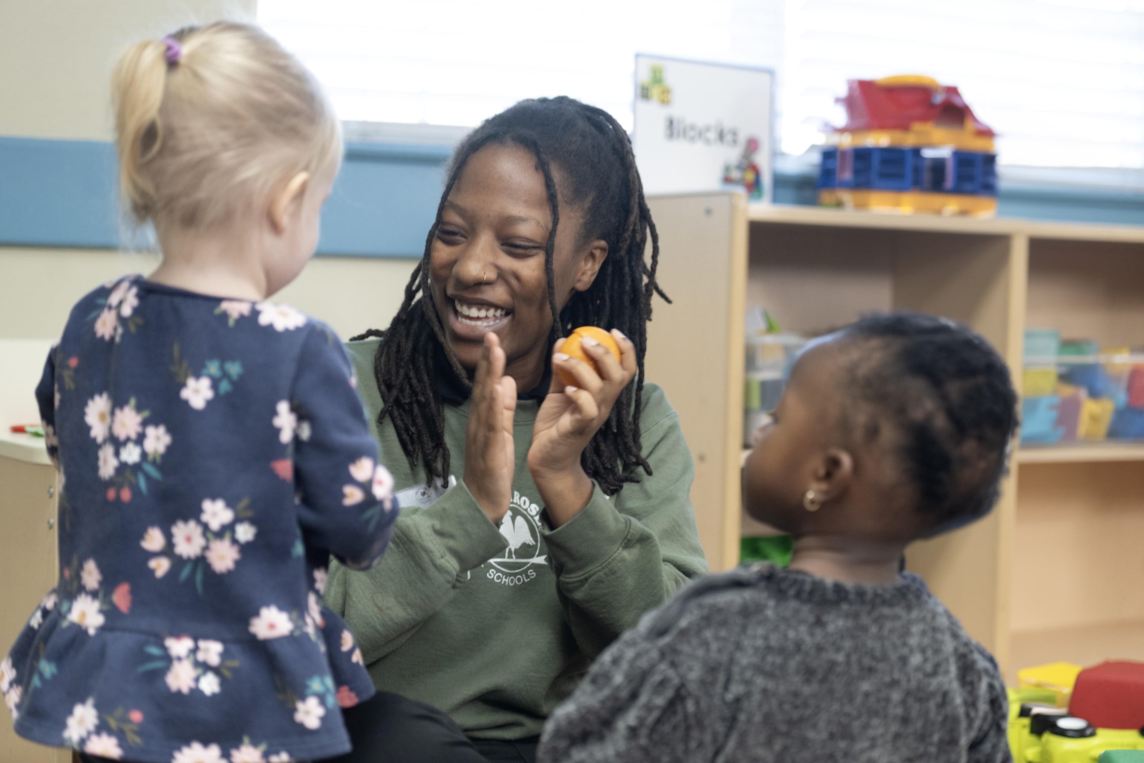 toddler teacher interacting with teacher