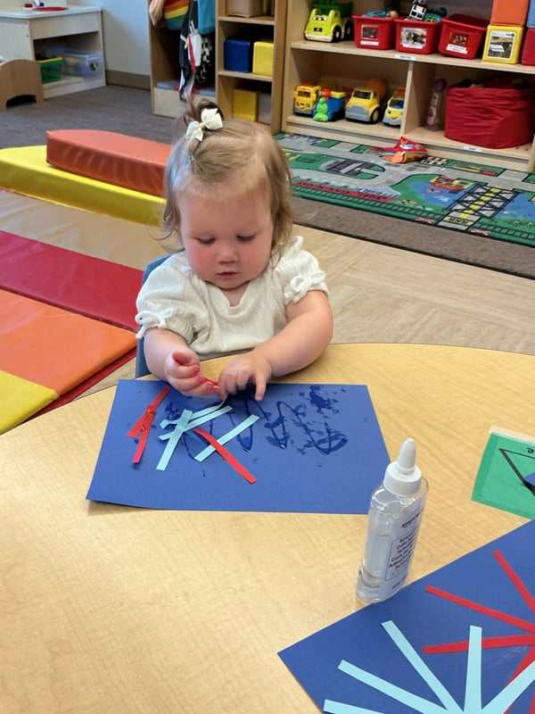 Toddler making fireworks using hand eye coordination