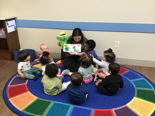 happy toddlers reading stories with fun and loving teachers , educational care for infants and toddlers in north west fort worth
