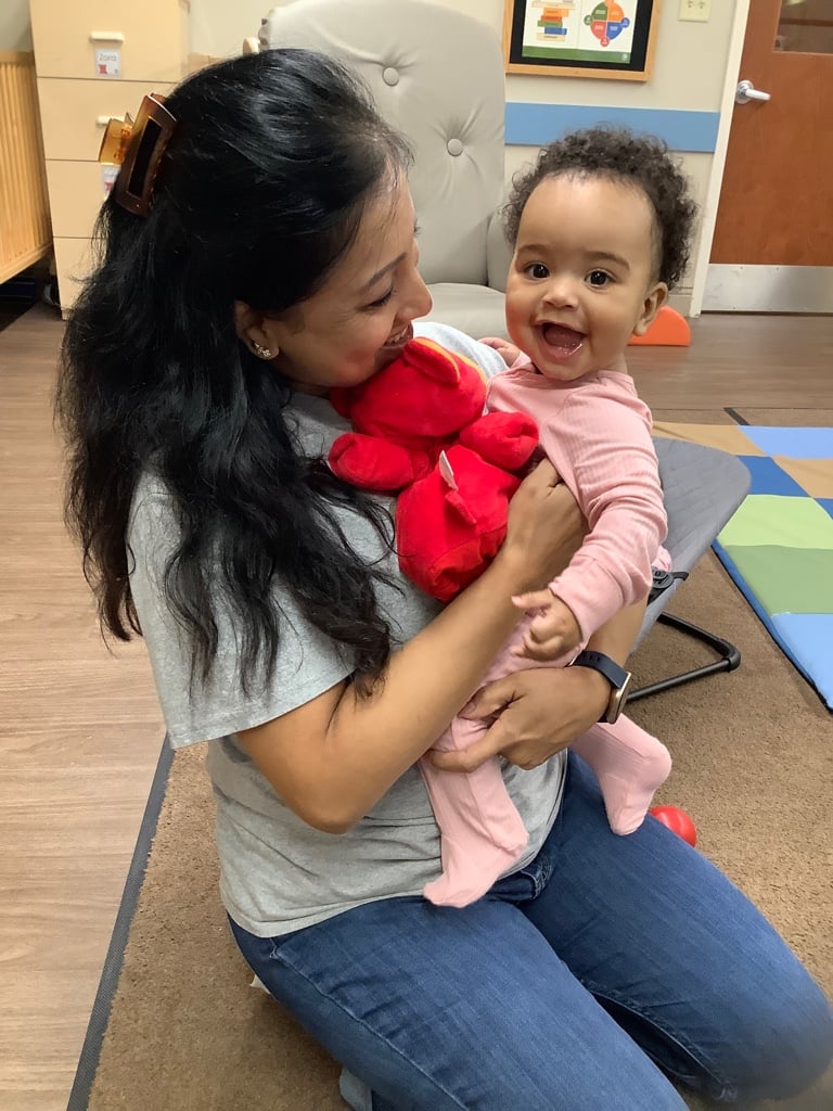 Happy Baby with a Loving and caring teacher interacting together to build social emotional skills