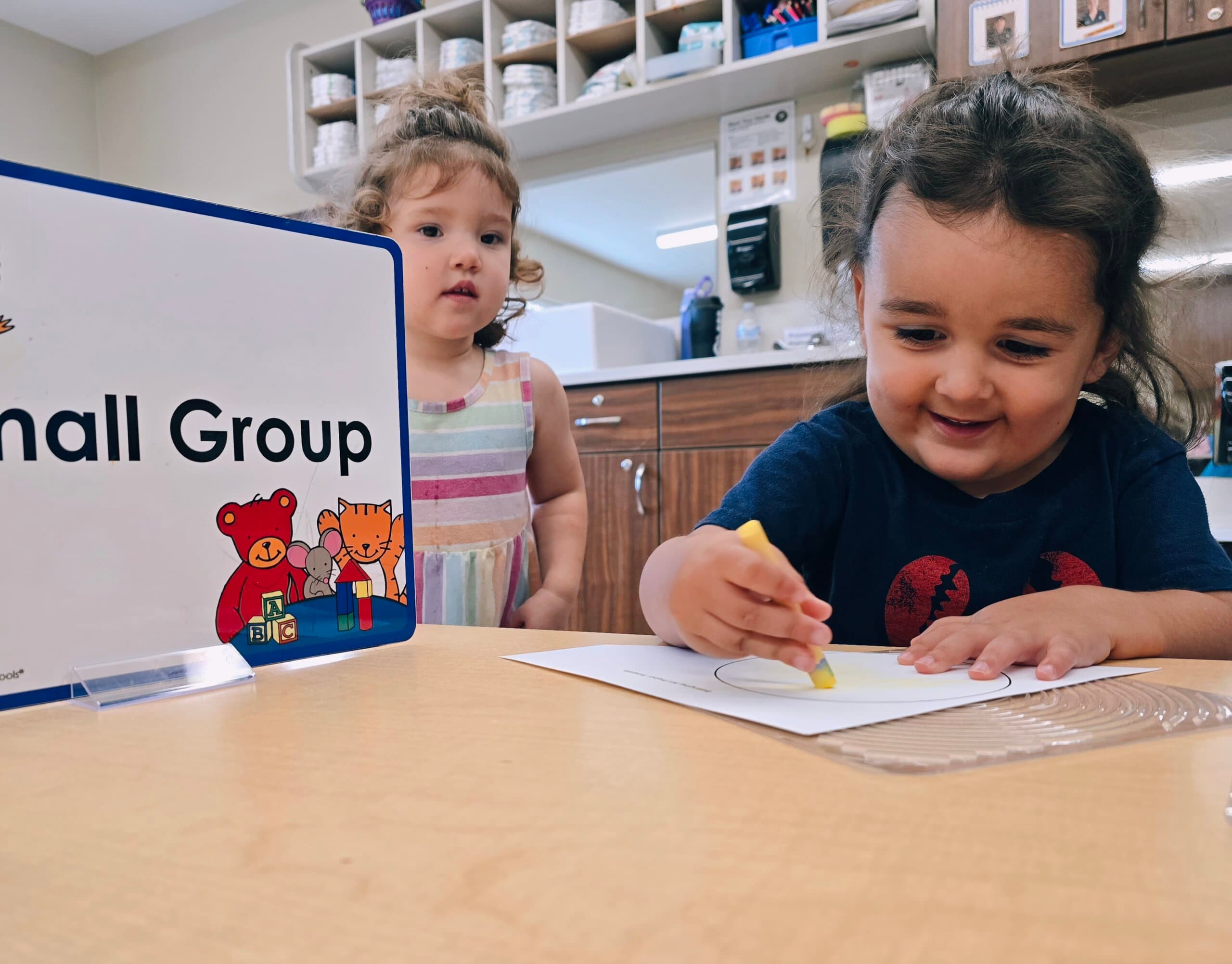 Children in Early Preschool creating an art project using paint at a Keller daycare.