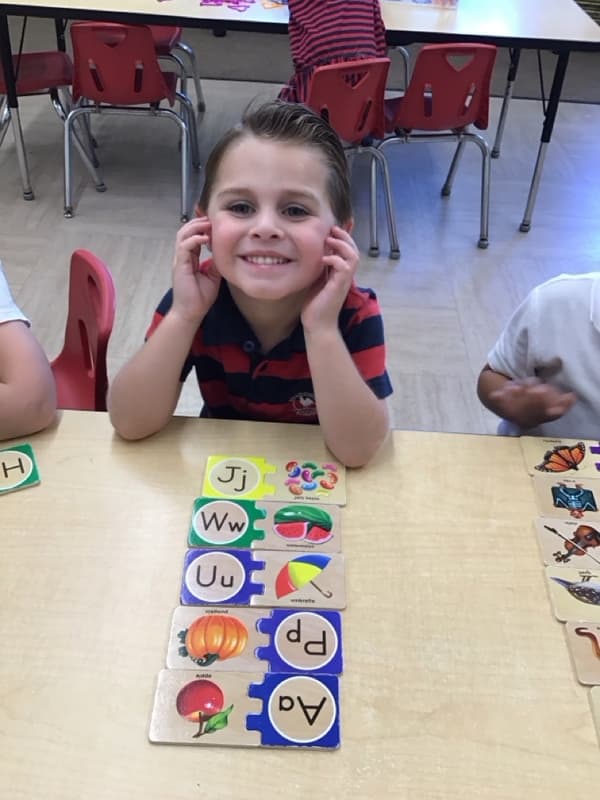 A child doing an alphabet puzzle.