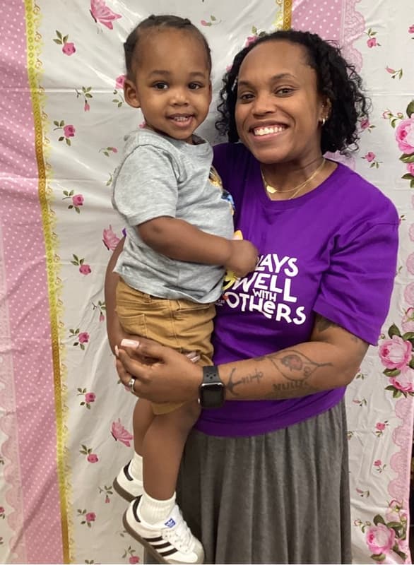 smiling mom with toddler