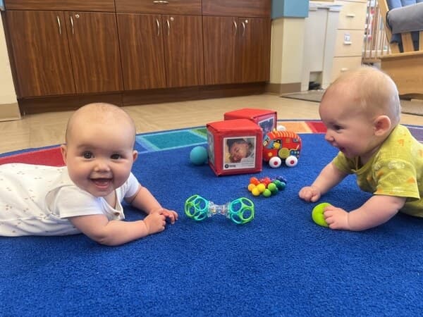 infants spend time on the floor with lots of educational toys
