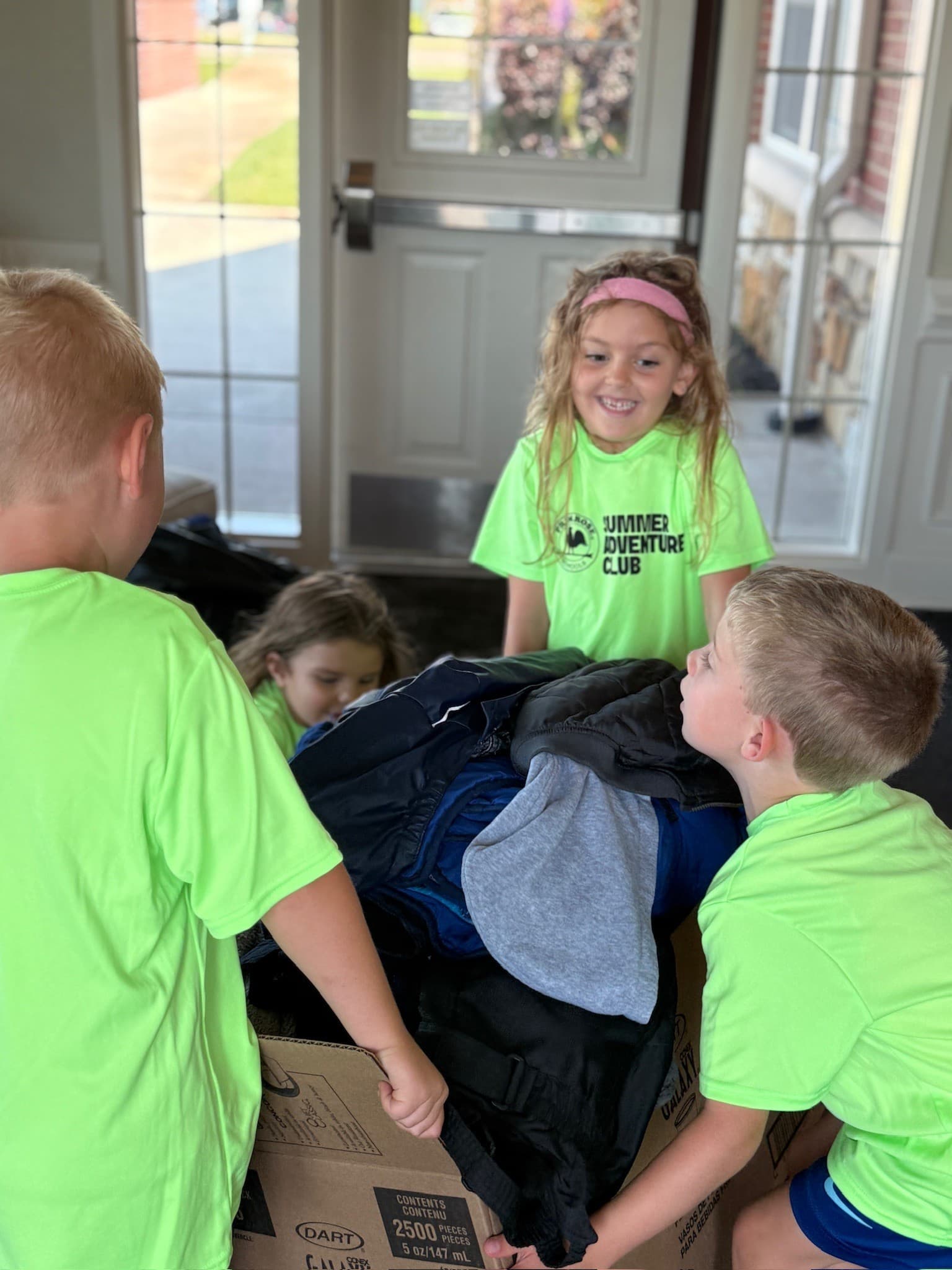 Children loading up donations. Hundreds of items collected.