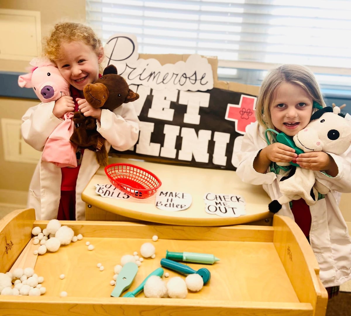 Kindergarten kids at vet clinic dramatic play center using their imagination.