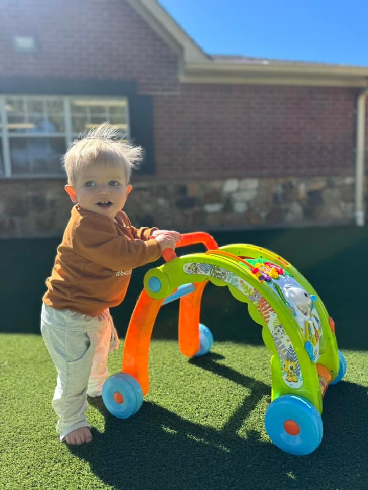 toddler walking on turf